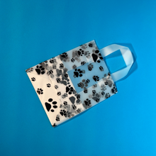 Load image into Gallery viewer, folded view of paw print tote bag