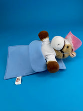 Load image into Gallery viewer, Plush brown horse in sleeping bag with pink hat and white shirt on