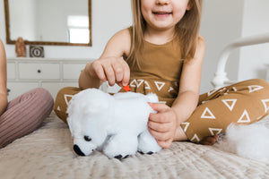 Girl making her plush polar bear