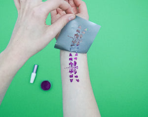 A temporary glitter tattoo on arm