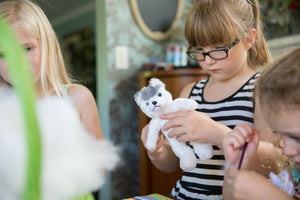 Girl making plush teddy Husky