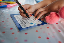 Load image into Gallery viewer, Child filing out adoption certificate for Teddy